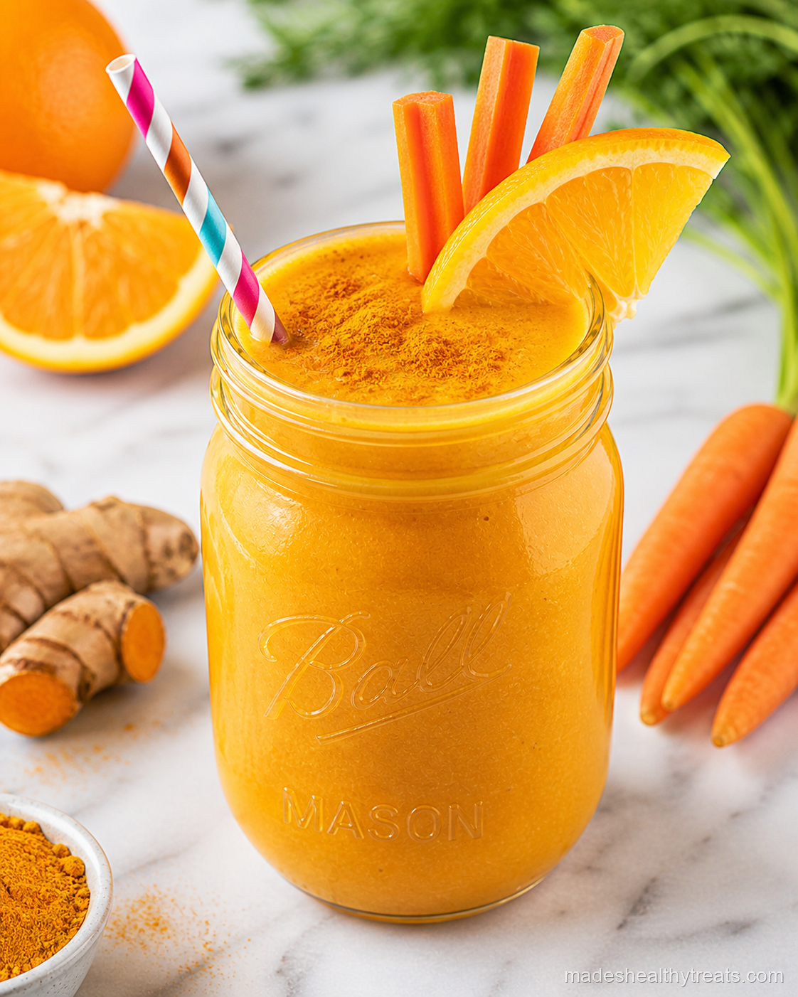 golden papaya carrot orange smoothie in a glass